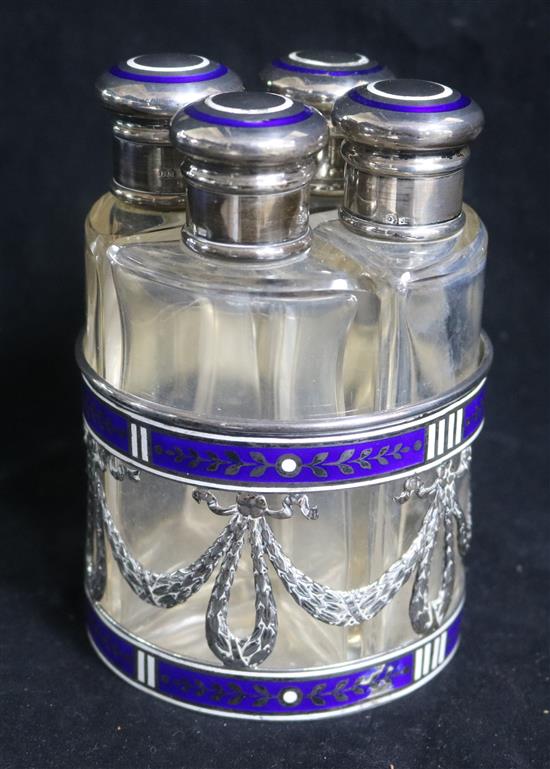 An early 20th century Austro-Hungarian silver and enamel mounted scent bottle stand fitted with four scent bottles,